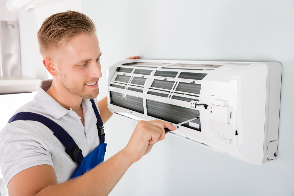 HVAC technician maintaining a ductless air conditioner in Los Gatos