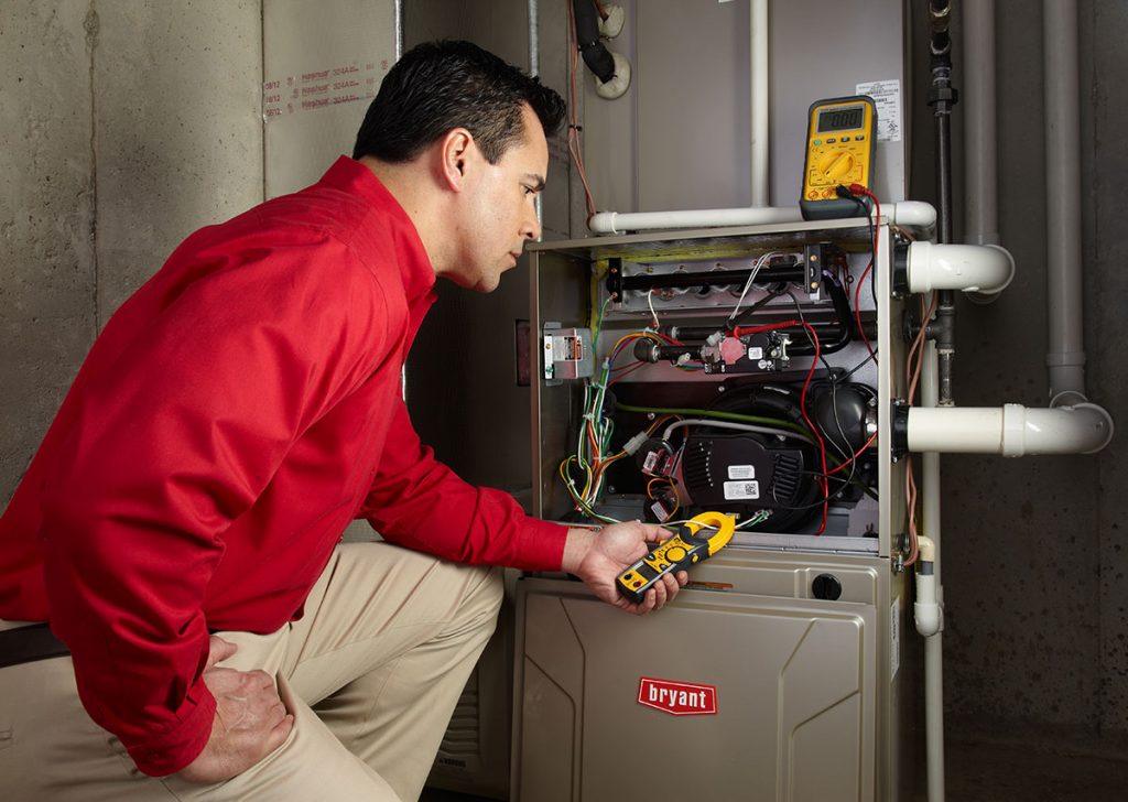Heating technician diagnosing a furnace repair in Los Gatos