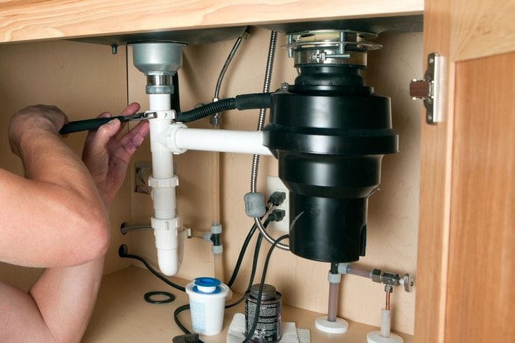 Plumber repairing a garbage disposal in Los Gatos